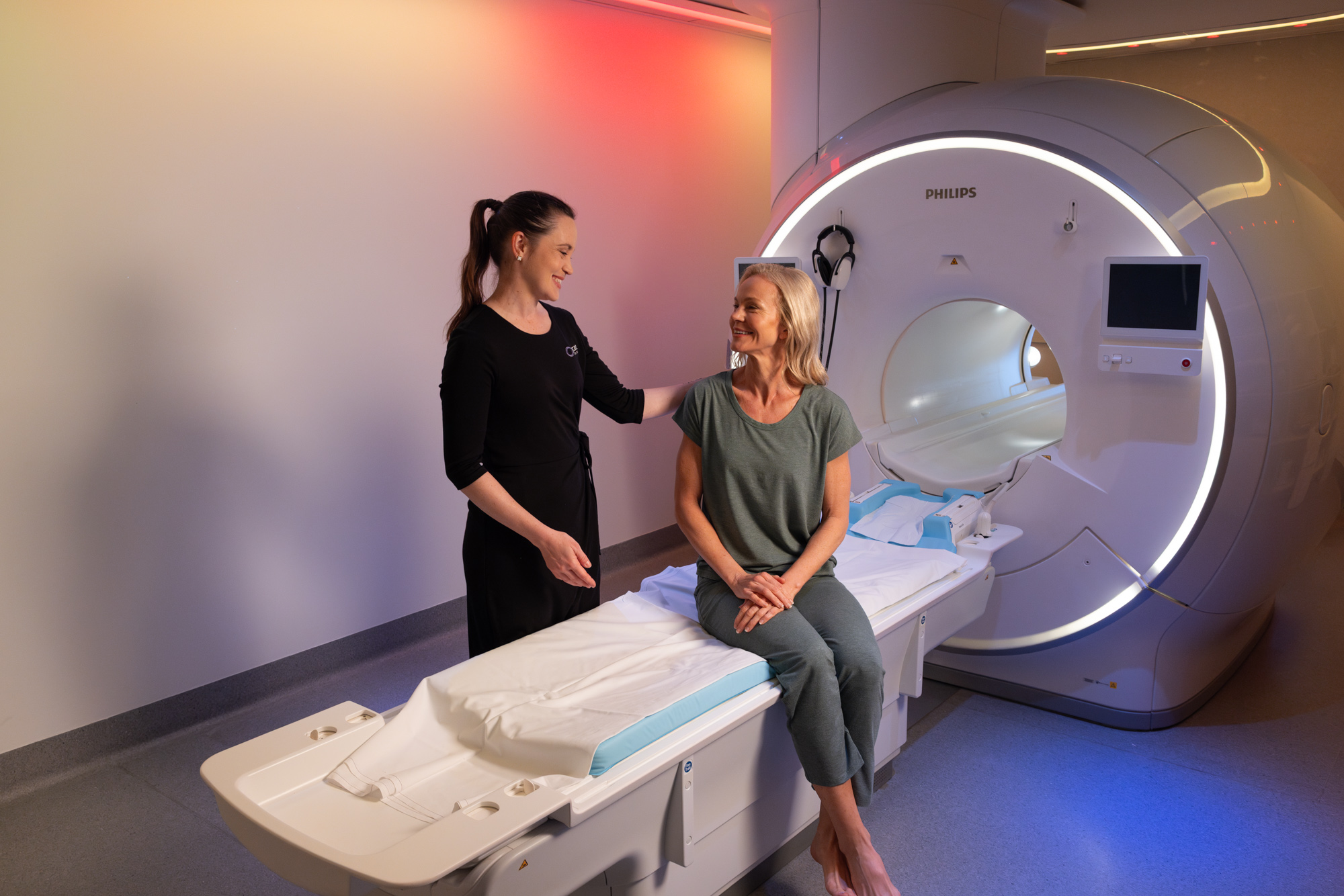 Woman sitting on MRI machine