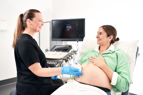 A female sonographer performs a pregnancy ultrasound